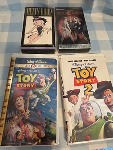 lot 159 image: Four VHS cassette tapes toy story, one and two also new inbox, Betty Boop and Chicago