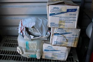 lot 121 image: (3) boxes of Crystal Dry carpet cleaning agent, large plastic container