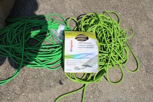 lot 129 image: Green extension cords plus CORDUCT cord protector
