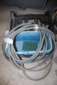 lot 49 image: Square trash bin dolly, (2) blue supply totes, garden hose