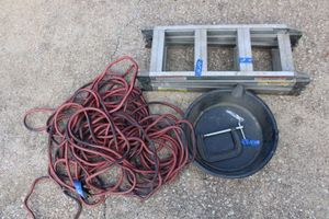 lot 95 image: Folding aluminum ramp, oil pan, and red extension cord