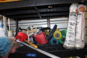 lot 101 image: Shelf contents - roller brushes, dust wands, plastic sheeting, Handheld steamer