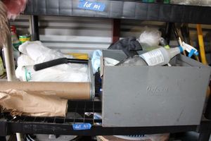 lot 102 image: Shelf contents - steel storage box with parts, dust cloths, handheld roll dispenser, trash bags