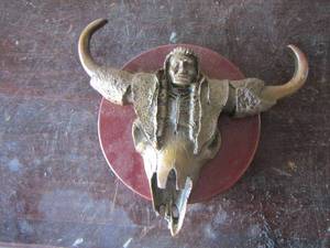 lot 110 image: NATIVE AMERICAN ART Bull skull metal wall piece
