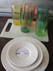lot 152 image: 5 color plastic drinking cups- cutting board- Faberware dishes - 1 saucer 3 salad plates 1 dinner plate-