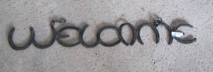 lot 209 image: HORSESHOE WELCOME SIGN approx 24