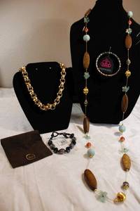 lot 37 image: Orange crystal bangle bracelet, Grosse fine jewelry bag, gold plate choker, oak wood bead and mixed bead necklace, and black glass bead bracelet. See descriptions.