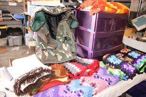 lot 185 image: Purple plastic storage unit with afghans, Ed Hardy bag and rolling camo bag..