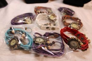 lot 49 image: (8) Purple, brown, pink, white, blue multi leather band quartz watches with snap closures (8 count)