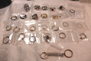 lot 48 image: (25) Fashion rings. Varying styles, materials, conditions, sizes. Includes replica faux Tiffany & Co diamond ring (marked  Tiffany & Co PT950 .72 ct but not real). Approx 25 count