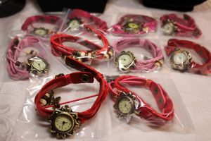 lot 41 image: (10) Red and pink multi leather band quartz watches with snap closures (10 count)