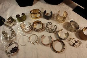 lot 98 image: Large selection of metal cuff bracelets.