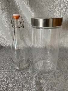 lot 44 image: Glass canister with lid and oil bottle with locking lid