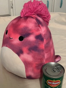 lot 106 image: Chameleon squishmellow (can of corn for size visual only)