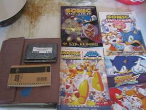 lot 115 image: Address booklets & Sonic Saga Series- Sonic Mega Man- Sonic Select Universe qty 4 comic books