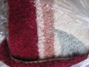 lot 124 image: Maroon rug size unknown due to being rolled up and wrapped for protection