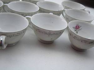 lot 58 image: 11 handled Royal Swirl tea cups with pink floral design