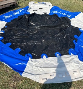 lot 17 image: Splash zone water trampoline , missing the slide and walking log piece but still functions great 9 air pump not included)