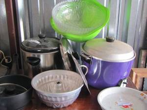 lot 63 image: kitchen lot of crock pots- Bundt cake pans- popcorn poppers plus