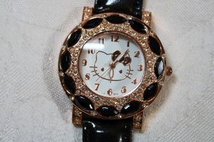 lot 7 image: Hello Kitty branded watch with leather strap.