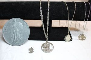 lot 13 image: Coin jewelry selection. Replica oversize 1916 quarter dollar, 1942 Standing Liberty (90% silver), 1939 Washington bust (90% silver), 1937 Buffalo nickel laser cut coin necklaces plus