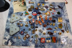 lot 8 image: Insignia and commemorative pins with denim hanging pin organizers. Includes a vintage Ready Kilowatt pin face.