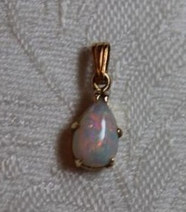 lot 107 image: 14K yellow gold and Opal tear drop pendant. Marked 14K 12L