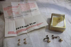 lot 101 image: 14K yellow Gold Pearl post earrings. Marked 14K on posts and butterfly backs. Includes a 2nd pair of clip pearl earrings in 14K Gold box. Likely gold but unmarked.