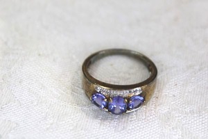 lot 97 image: Sterling Silver Tanzanite and diamond ring. Marked 925 Thailand. Size 10