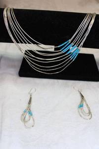 lot 82 image: Sterling Silver 10-strand and Turquoise demi necklace and earring set. Marked sterling on cone. Has matching ear wire earrings (marked Sterling).