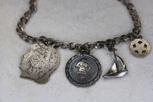 lot 84 image: Sterling Silver charm bracelet with charms. Horoscope charm and bracelet both marked Sterling. 6.5L