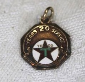 lot 85 image: 14K Gold and enamel 20 year Texaco service medallion. Marked 14K Robbins.