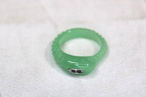 lot 89 image: Carved Jade figural snake ring with Sapphire eyes. Size