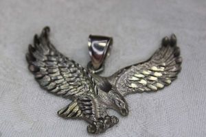 lot 74 image: Sterling Silver figural eagle pendant. Large bale. Marked 925. 2.25W x 2H