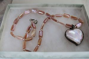 lot 62 image: Sterling Silver shell and button pearl necklace with sterling pendant in heart form in Coldwater Creek box. Marked 925 Luc on pendant and 925 on lobster clasp. 18L