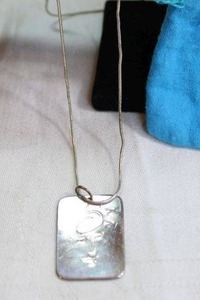 lot 63 image: Sterling Silver Italian rope chain necklace with abstract face pendant. Necklace marked 925 Italy 24L w. storage pouch