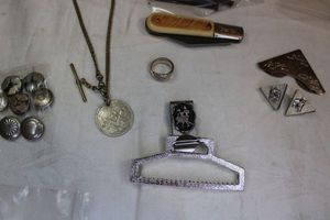 lot 43 image: Western lot. Includes Barlow knife, collar tips, square head vintage hand wrought nails, square dance hankie belt clip (unusual), spoon ring, button covers, Rotary pocket watch fob with medallion