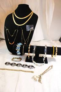 lot 44 image: Mid century jewelry. Includes bracelet selection, nugget style necklaces, Cuban link bracelet, acrylic necklace