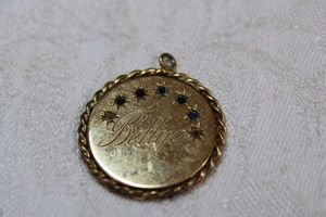 lot 45 image: 12K yellow gold 25th-anniversary pendant with stones. Marked 12K G Inscribed Bill on one side, Bettye on reverse. 1W