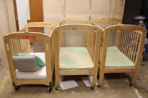 lot 168 image: 3 baby cribs as shown (one has broken Plexiglas)
