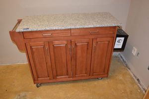 lot 178 image: Rolling storage cabinet with granite top and towel bars on the sides