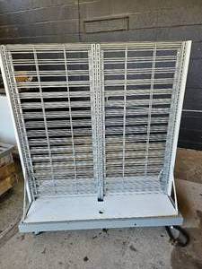 lot 187 image: Heavy Duty Rolling display stand with 1000 LB weight class. Has a solid 2steel base with 2 removable wire steel display racks. Comes with one base and two racks in box.