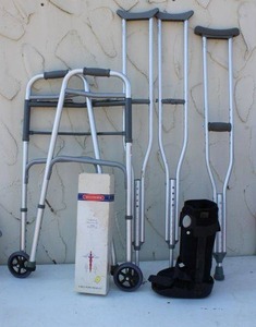 lot 20 image: Kids size crutches, walker, boot, and vintage overhead traction set