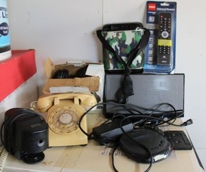 lot 30 image: Electronics - Bose speaker, vintage telephone, Discman CD player, Unopened Universal remote, Camo portable music player, Onn wireless headphones
