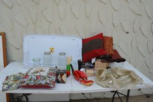 lot 54 image: Ball jars, Avon bottles, pillows, and placemats