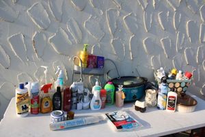 lot 57 image: Cleaners, shower caddy, soaps, crockpot, French white baking dish, plastic chair cover and more