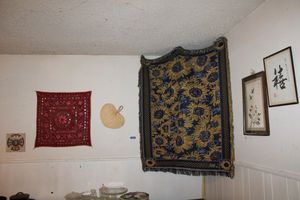 lot 11 image: Souvenir dcor Asian wall art, red scarf, decorative tile and more