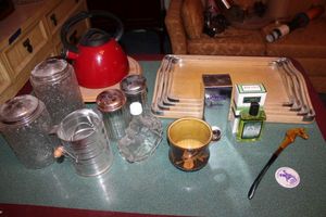 lot 23 image: Vintage nesting wooden platters, Red teapot, glass cannisters, sifter and colognes