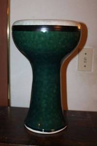 lot 8 image: Ceramic green Hand Drum. Top skin is very thin. Comes with its own protective case