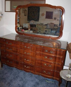 lot 34 image: Solid Cherry wood dresser with mirror. Dresser has glass top. Beautiful piece